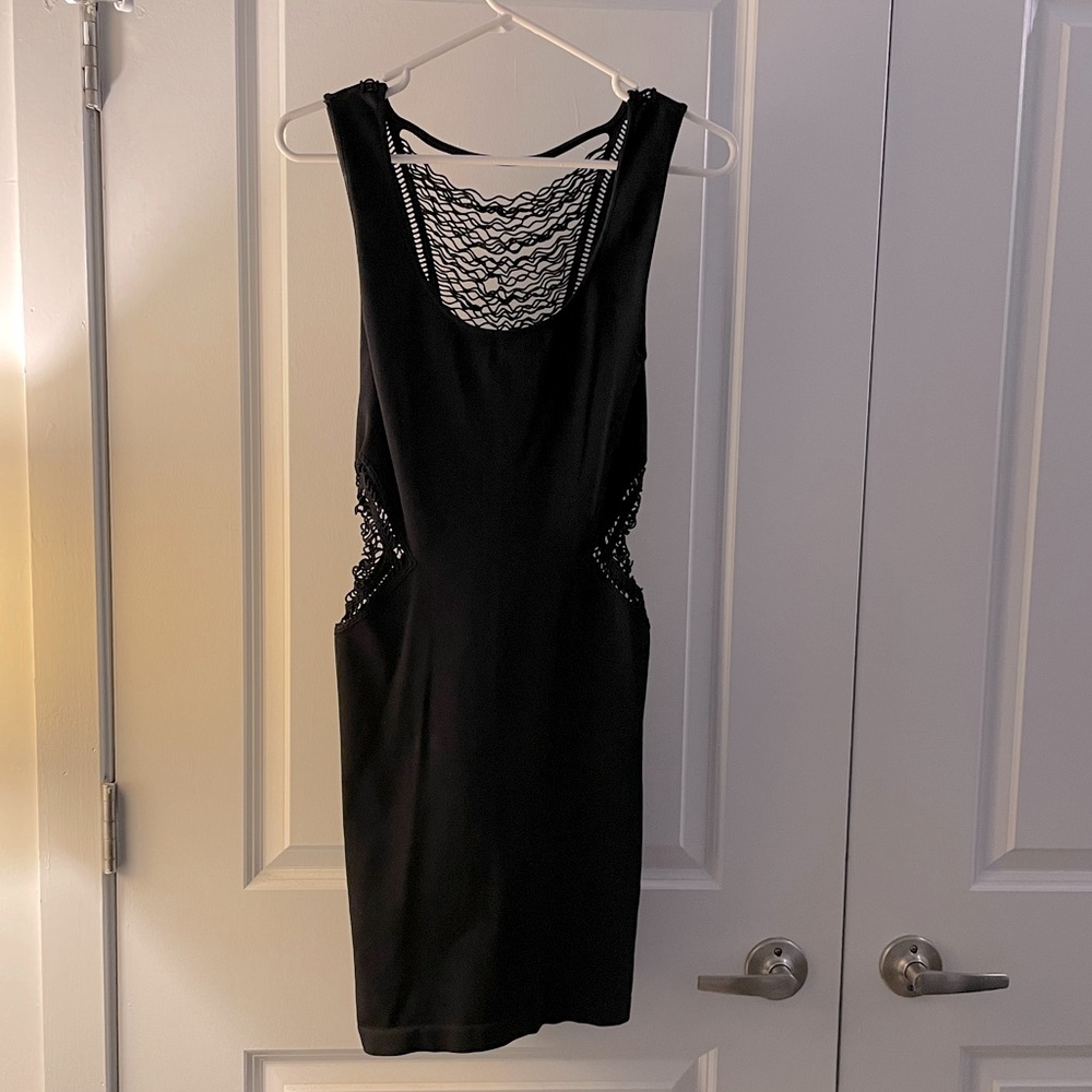 Bebe form fitting mini little black dress with aide and back cutouts